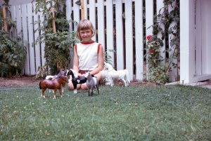 That's me with my Breyer plastic horses in Grandma's back yard